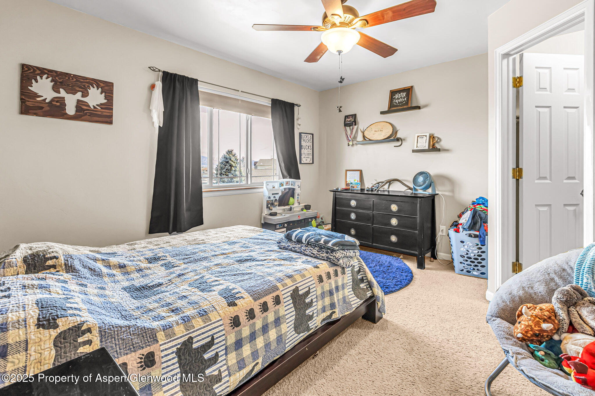 1357 West Spruce Court Rifle, CO 81650 - Photo 24 of 38 a bedroom with a bed and dresser