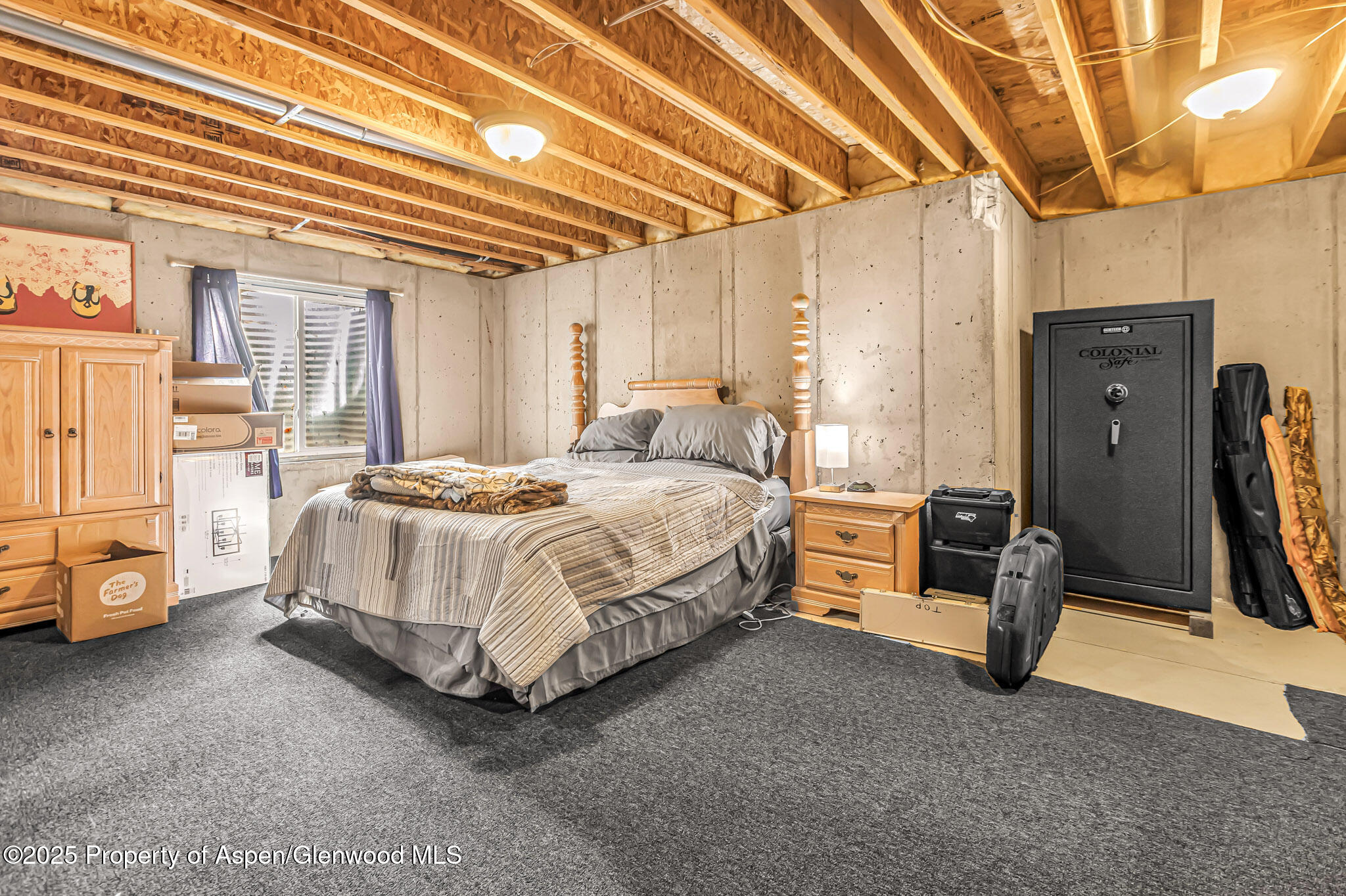 1357 West Spruce Court Rifle, CO 81650 - Photo 27 of 38 a spacious bedroom with a bed and wooden floor