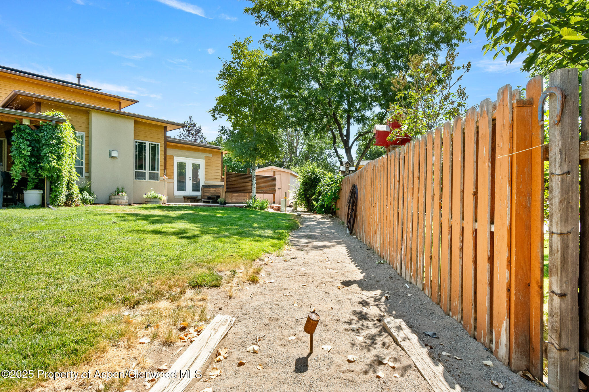 1357 West Spruce Court Rifle, CO 81650 - Photo 34 of 38 a view of a house with a small yard and large trees