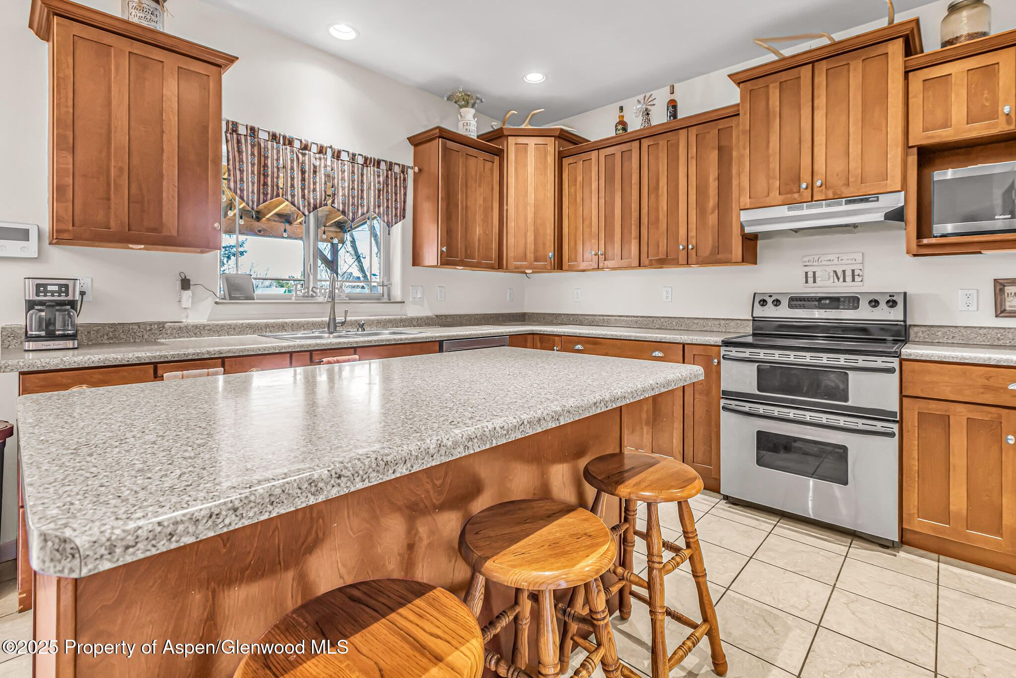 1357 West Spruce Court Rifle, CO 81650 - Photo 10 of 38 a kitchen with stainless steel appliances granite countertop a sink stove and cabinets