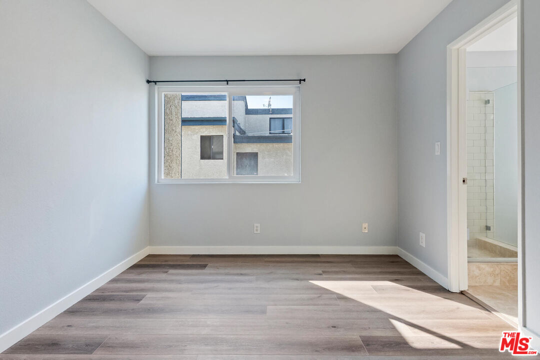 29239 Heathercliff Road, Unit 12 Malibu, CA 90265 - Photo 29 of 32 a view of an empty room with wooden floor and a window