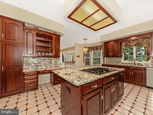 a kitchen with stainless steel appliances granite countertop a stove sink and cabinets