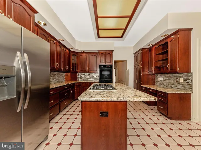 a kitchen with granite countertop a sink stainless steel appliances and cabinets
