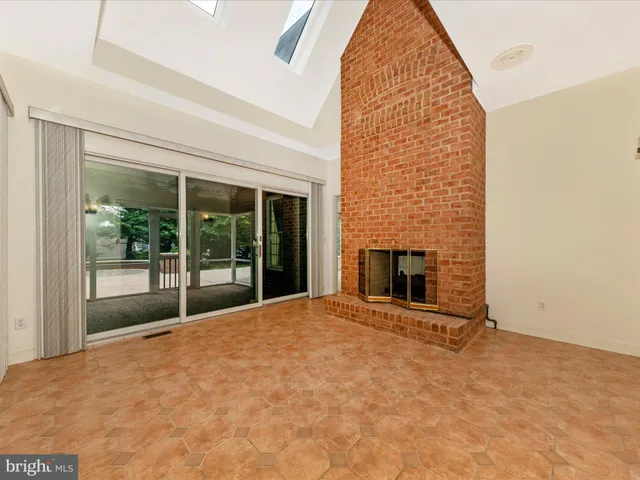 a view of a living room with hardwood floor and a ceiling fan