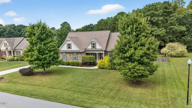 a view of house with garden space and sitting area