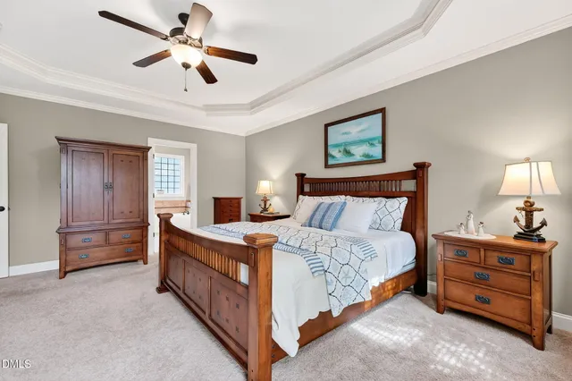 a bedroom with a bed and a chandelier