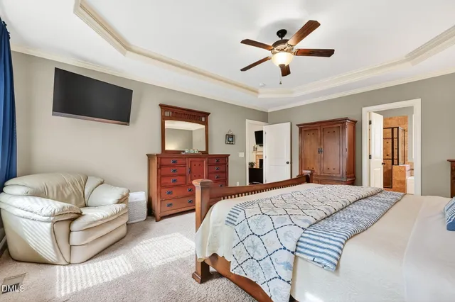 a bedroom with a large bed a flat screen tv and couches