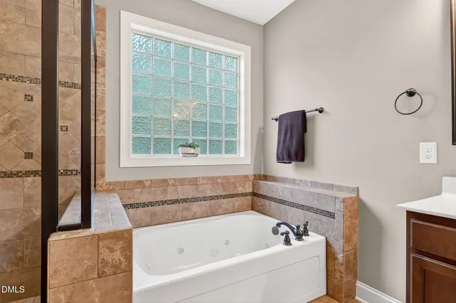 a bathroom with a bathtub and a window