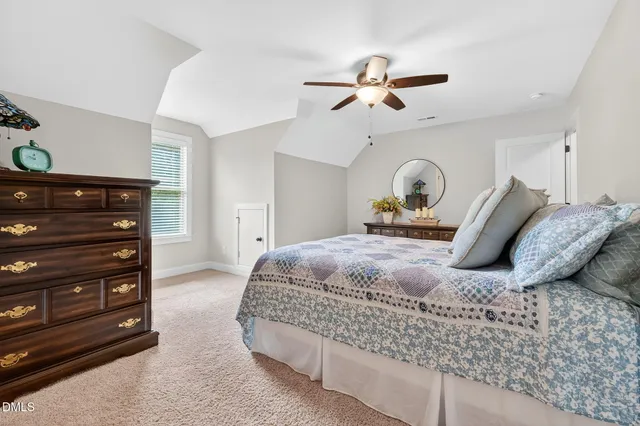 a bedroom with a bed and ceiling fan