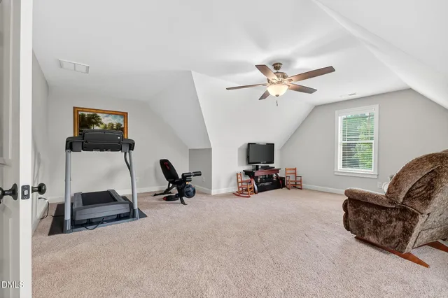 a view of a livingroom with workspace and a car