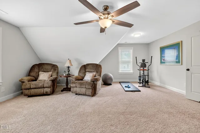 a living room with furniture gym equipment and a window