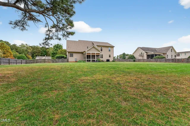 an aerial view of a house with swimming pool and outdoor seating