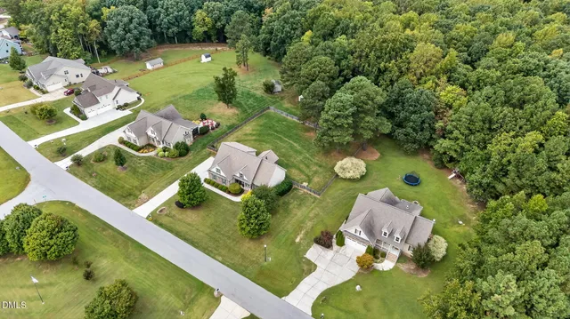 an aerial view of a house with a yard basket ball court and outdoor seating
