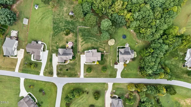 a view of a house with a yard and potted plants