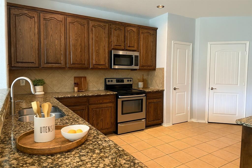 2047 Jack County Drive Forney, TX 75126 - Photo 4 of 20 a kitchen with a appliances and cabinets