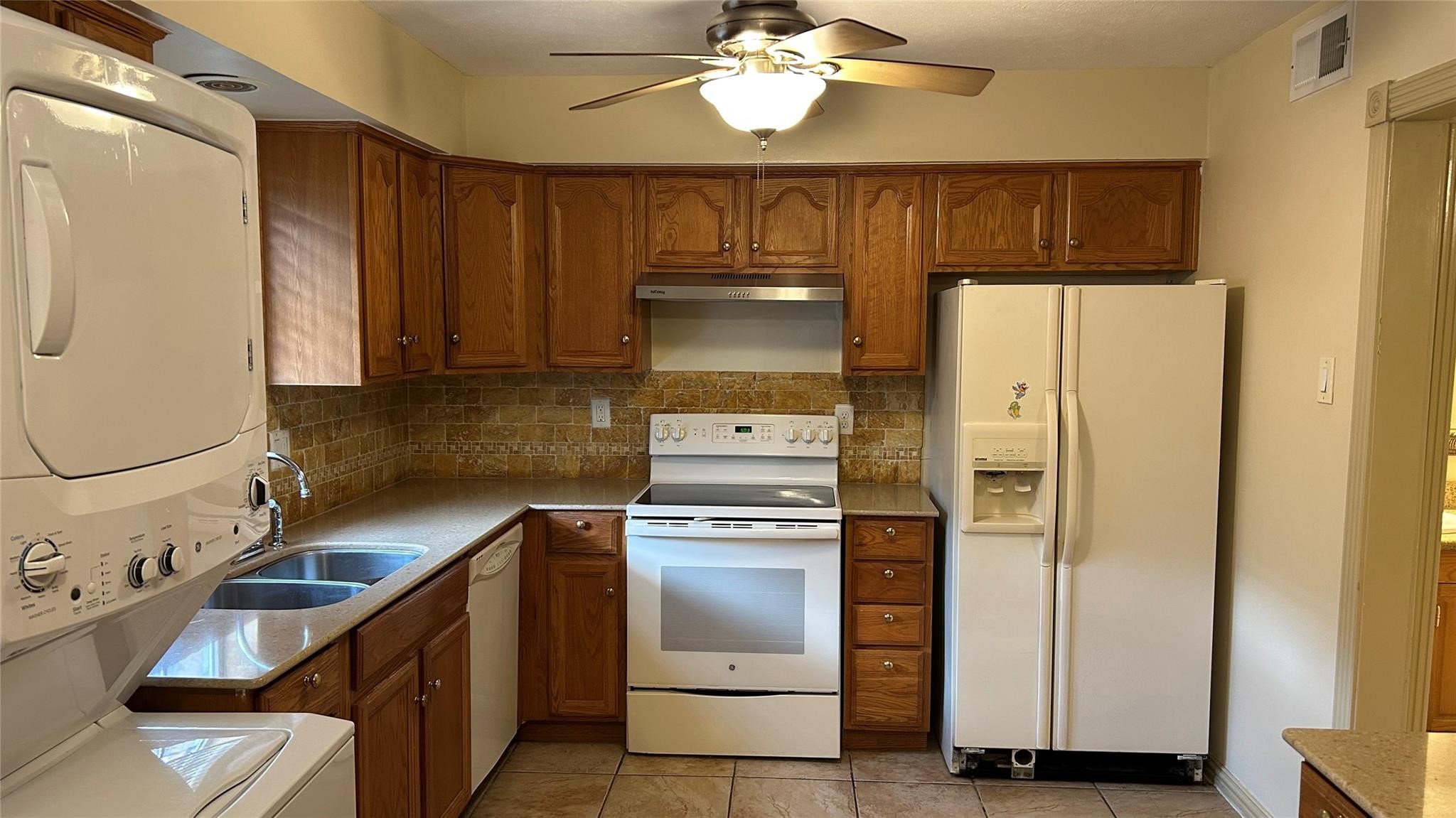7600 Burgoyne Road, Unit 115 Houston, TX 77063 - Photo 11 of 14 a kitchen with stainless steel appliances granite countertop a refrigerator a stove and a sink with wooden floor
