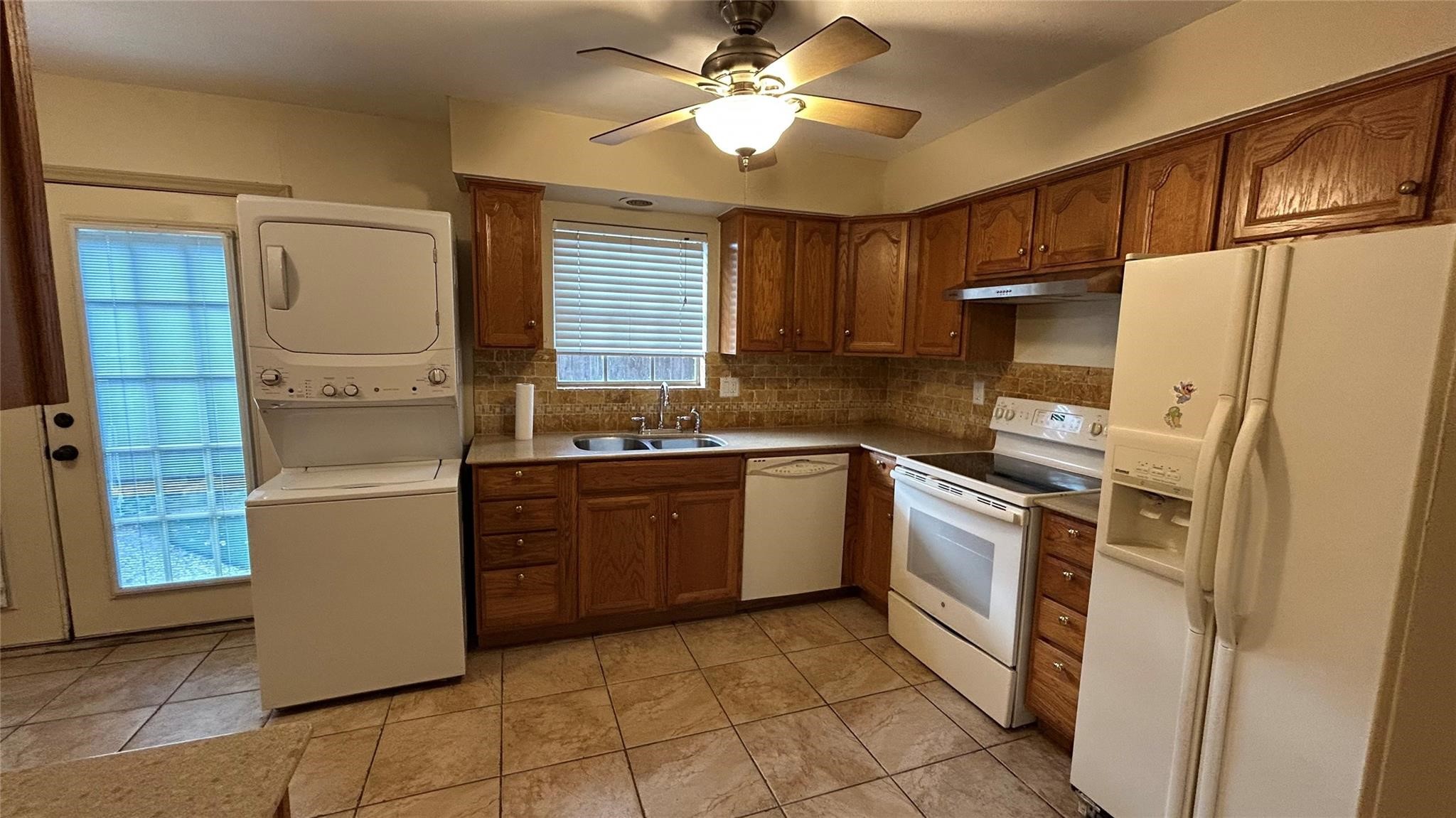 7600 Burgoyne Road, Unit 115 Houston, TX 77063 - Photo 12 of 14 a kitchen with granite countertop a refrigerator and a stove top oven