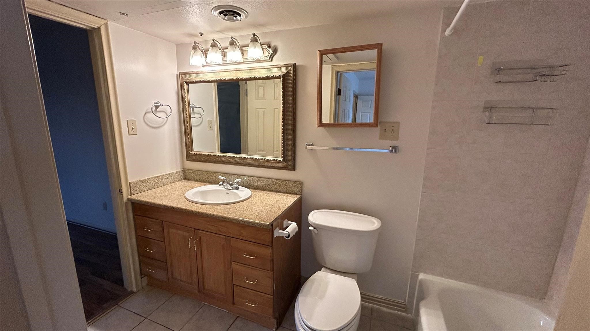 7600 Burgoyne Road, Unit 115 Houston, TX 77063 - Photo 6 of 14 a bathroom with a toilet sink and mirror