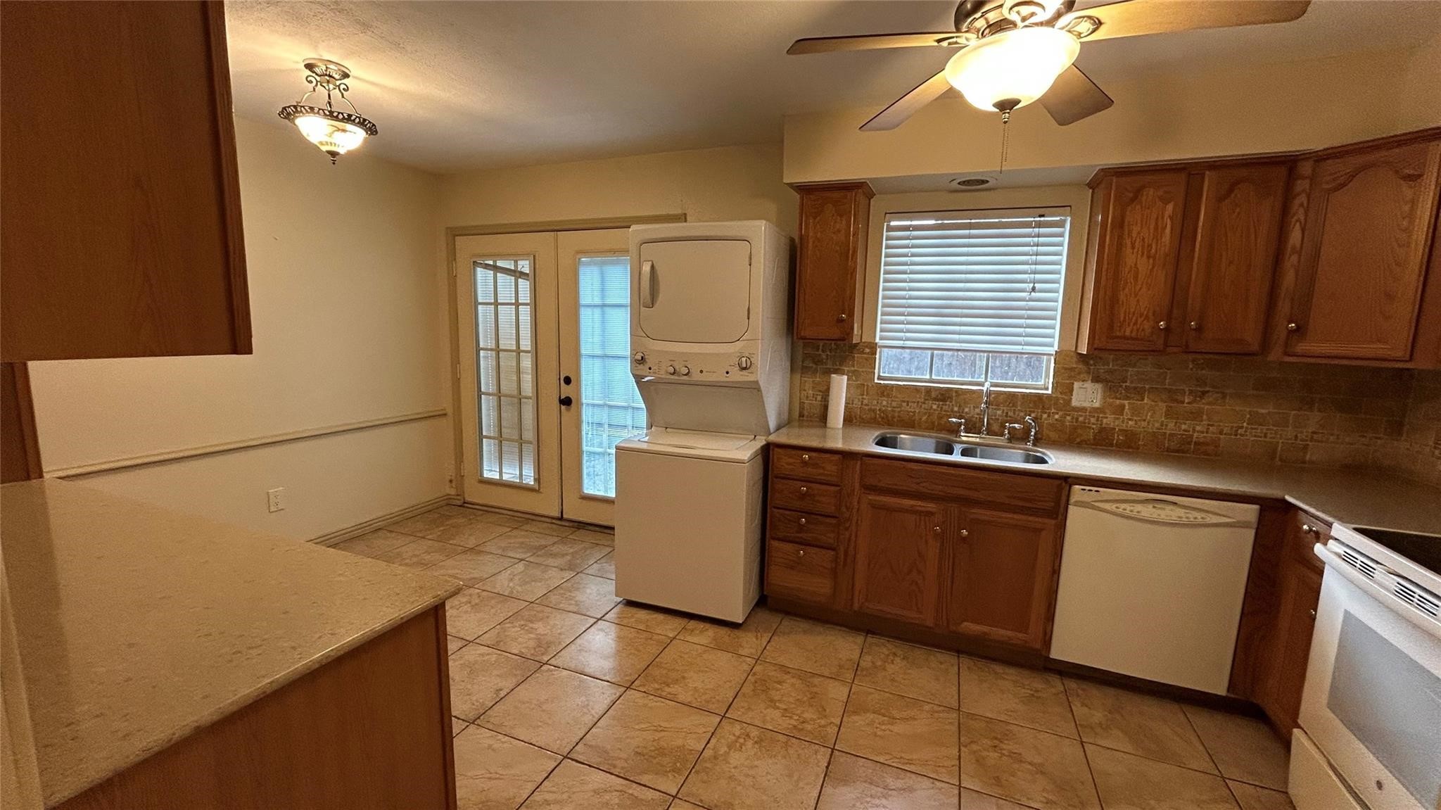 7600 Burgoyne Road, Unit 115 Houston, TX 77063 - Photo 10 of 14 a kitchen with a sink a refrigerator and cabinets