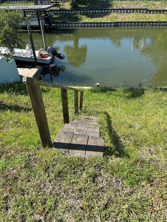 111 Lewis Street Edgewater, FL 32141 - Photo 9 of 11 a view of a lake with a bench and lake view