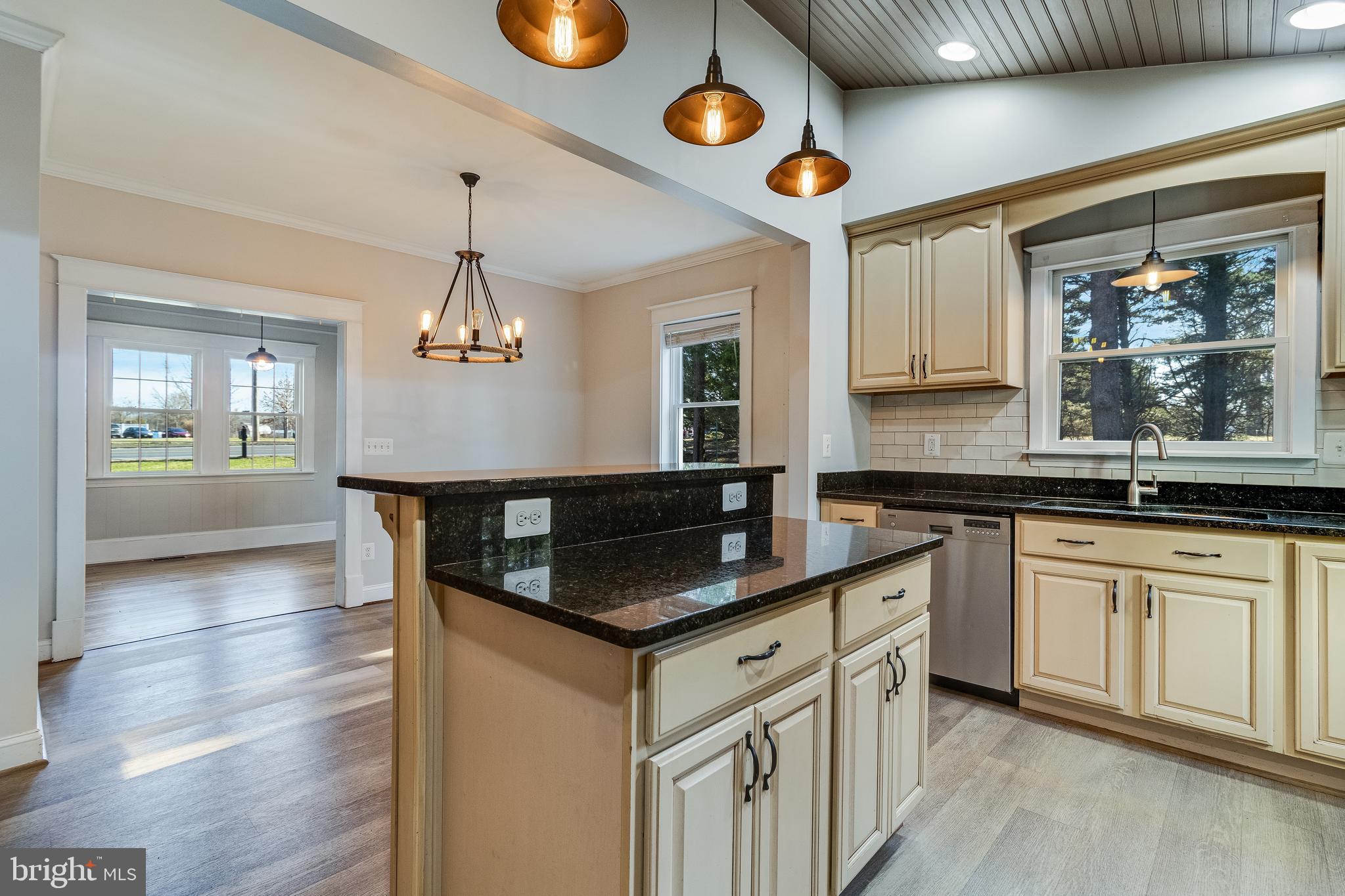 28055 Old Village Road Mechanicsville, MD 20659 - Photo 14 of 56 a kitchen with stainless steel appliances granite countertop a sink and a stove