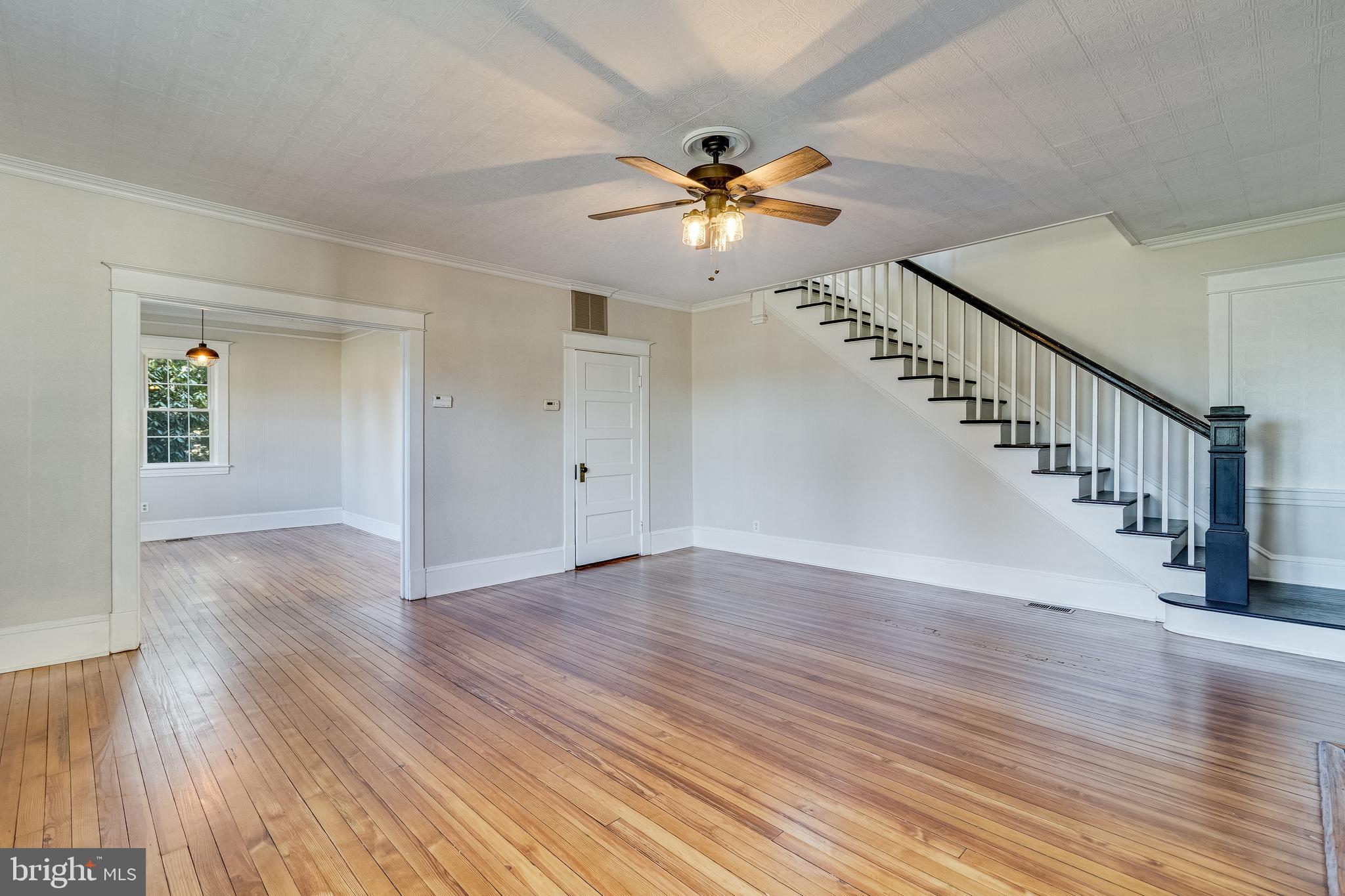 28055 Old Village Road Mechanicsville, MD 20659 - Photo 17 of 56 a view of an empty room with wooden floor and a chandelier fan