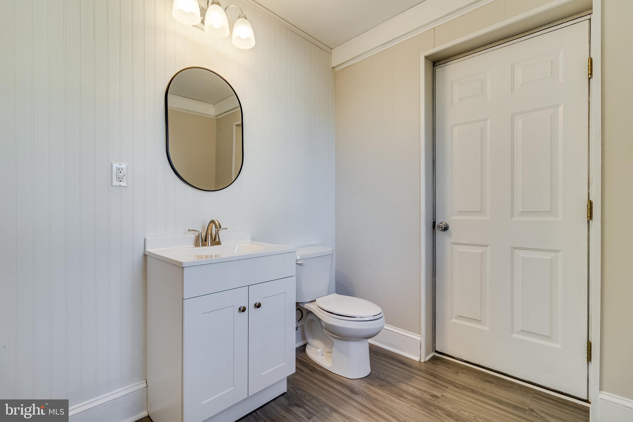 28055 Old Village Road Mechanicsville, MD 20659 - Photo 27 of 56 a bathroom with a toilet a sink and a mirror