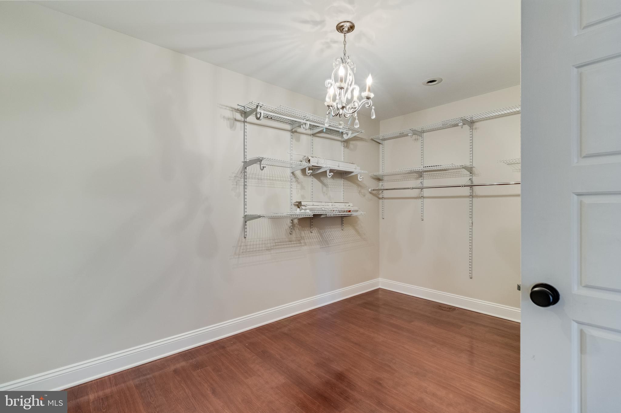 28055 Old Village Road Mechanicsville, MD 20659 - Photo 32 of 56 a view of a room with wooden floor and chandelier