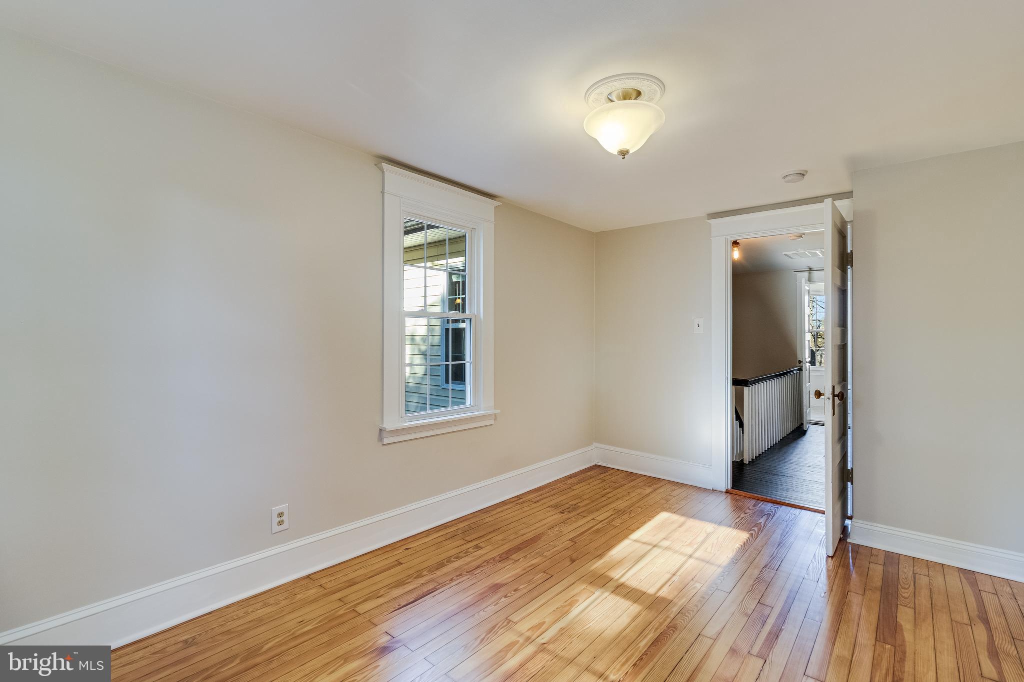 28055 Old Village Road Mechanicsville, MD 20659 - Photo 36 of 56 an empty room with wooden floor and windows