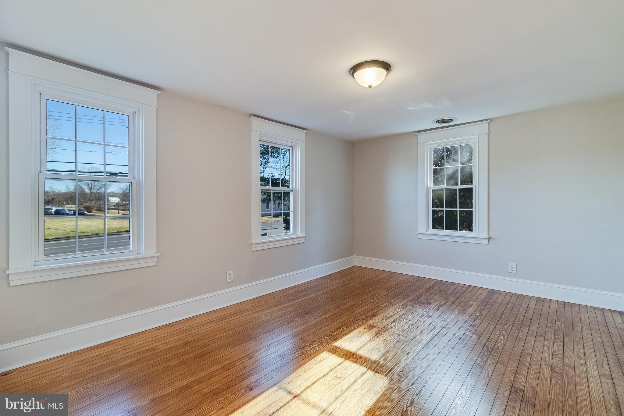 28055 Old Village Road Mechanicsville, MD 20659 - Photo 40 of 56 a view of an empty room with wooden floor and a window
