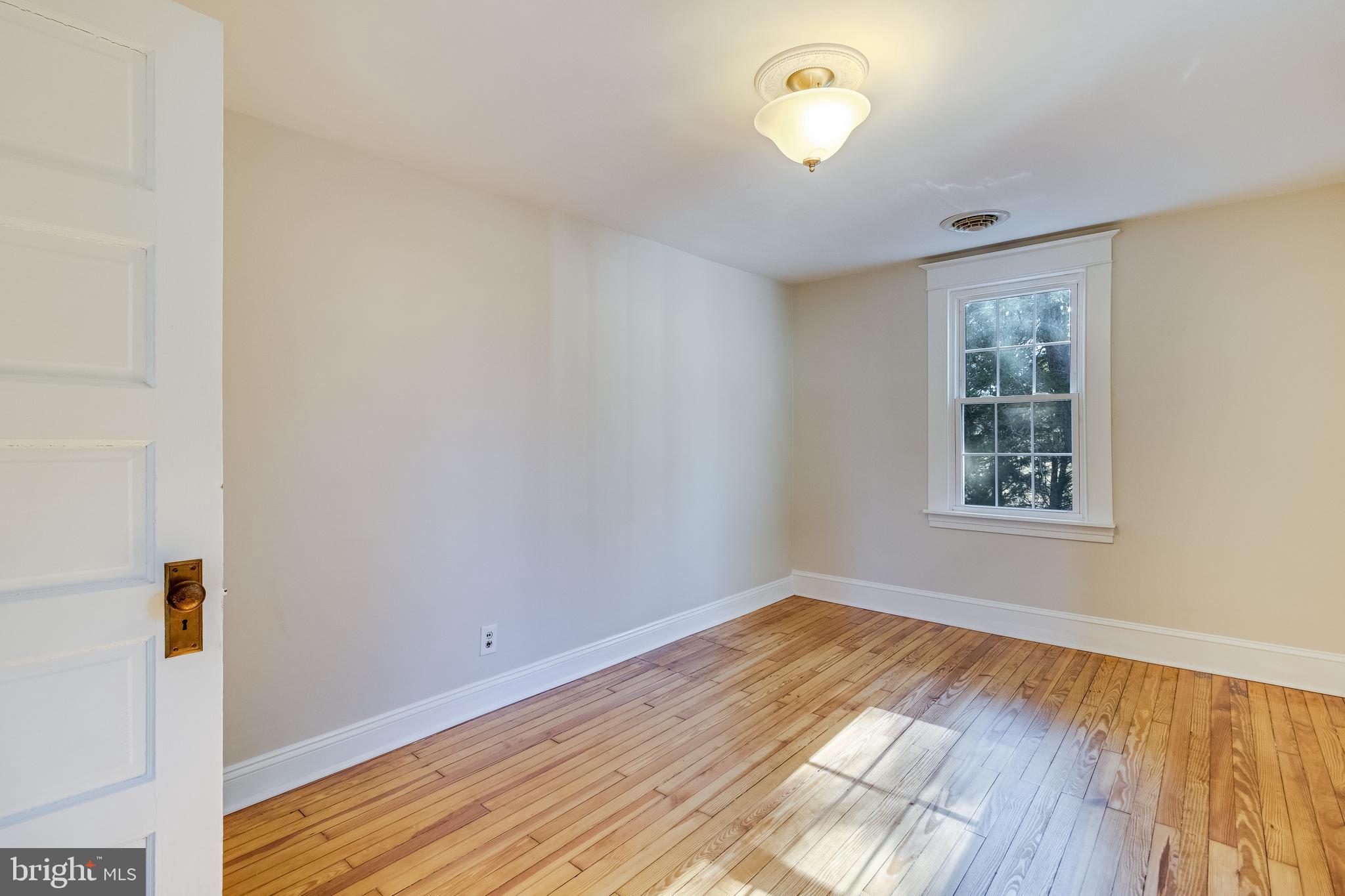 28055 Old Village Road Mechanicsville, MD 20659 - Photo 42 of 56 a view of empty room with wooden floor and fan