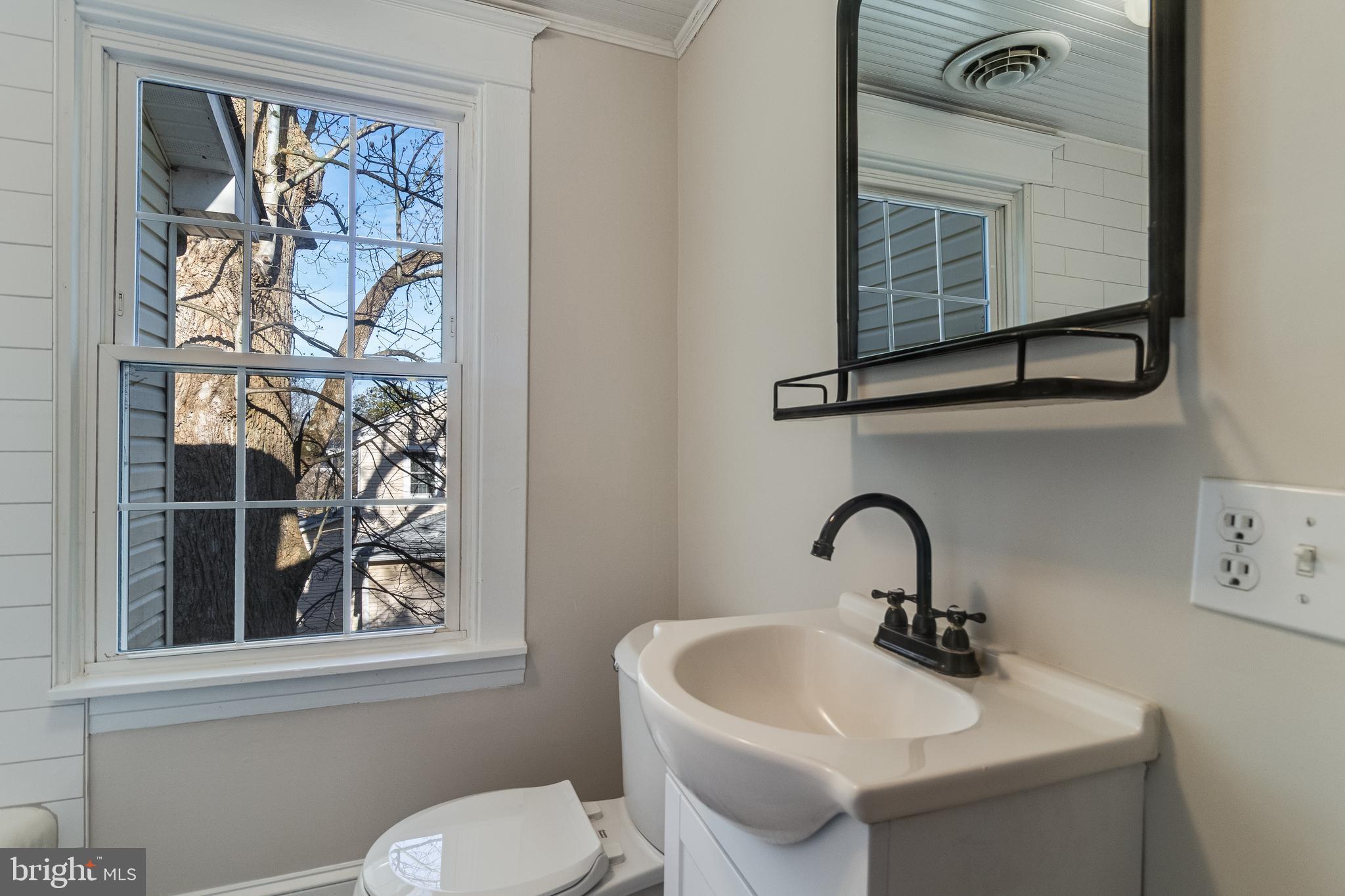 28055 Old Village Road Mechanicsville, MD 20659 - Photo 44 of 56 a bathroom with a toilet sink and mirror