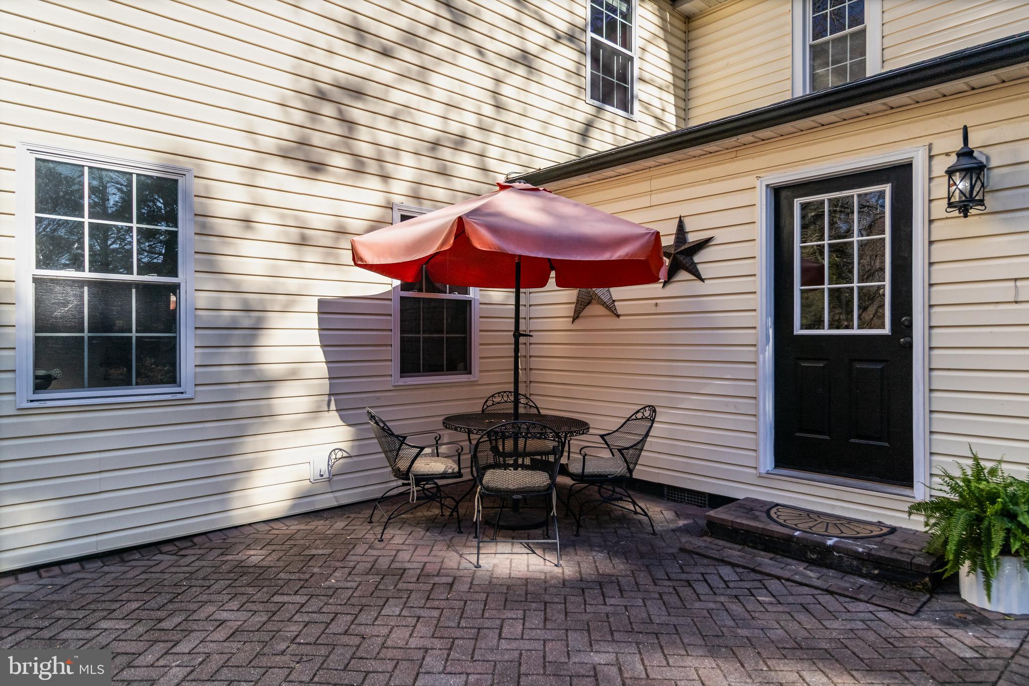 28055 Old Village Road Mechanicsville, MD 20659 - Photo 5 of 56 a view of a patio with a table and chairs under an umbrella