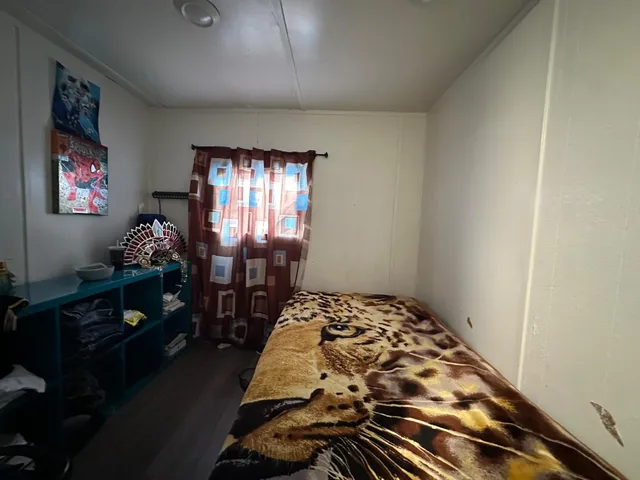 a bed sitting in a bedroom next to a window