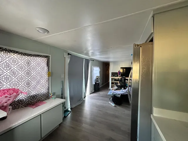 a kitchen with a stove and a flat screen tv