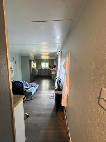 a view of hallway with wooden floor