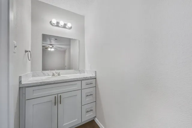 a view of an empty room with a ceiling fan