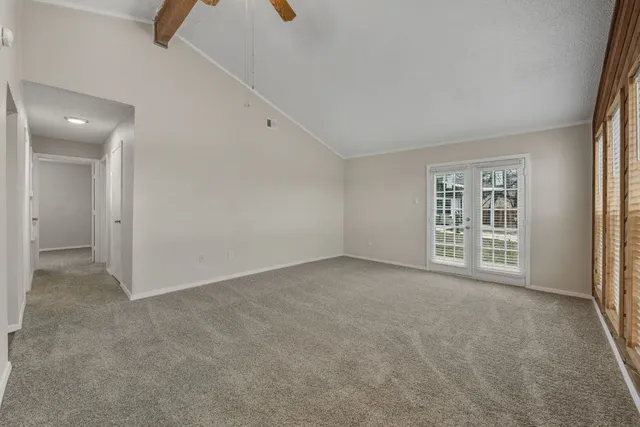 an empty room with windows and pillars in it