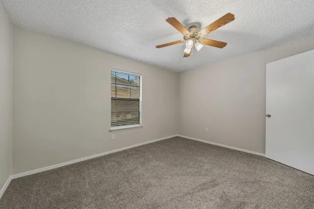 a kitchen with white cabinets and appliances