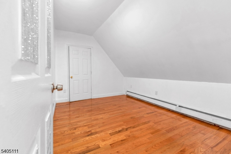 25 Oak Street, Unit 25 Paterson, NJ 07501 - Photo 12 of 25 a view of a room with wooden floor and white walls