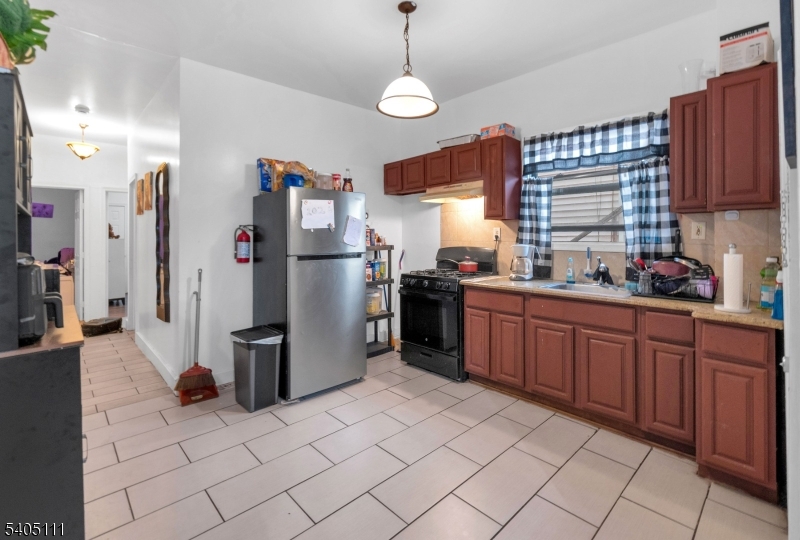 25 Oak Street, Unit 25 Paterson, NJ 07501 - Photo 4 of 25 a kitchen with refrigerator and window