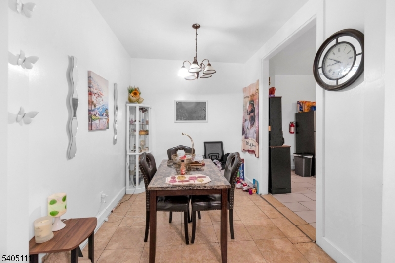 25 Oak Street, Unit 25 Paterson, NJ 07501 - Photo 5 of 25 a view of a dining room with furniture and a chandelier