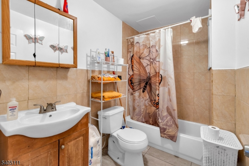 25 Oak Street, Unit 25 Paterson, NJ 07501 - Photo 7 of 25 a bathroom with a sink toilet and mirror