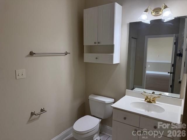8913 Meadow Vista Road Charlotte, NC 28213 - Photo 21 of 30 a bathroom with a sink vanity mirror and toilet