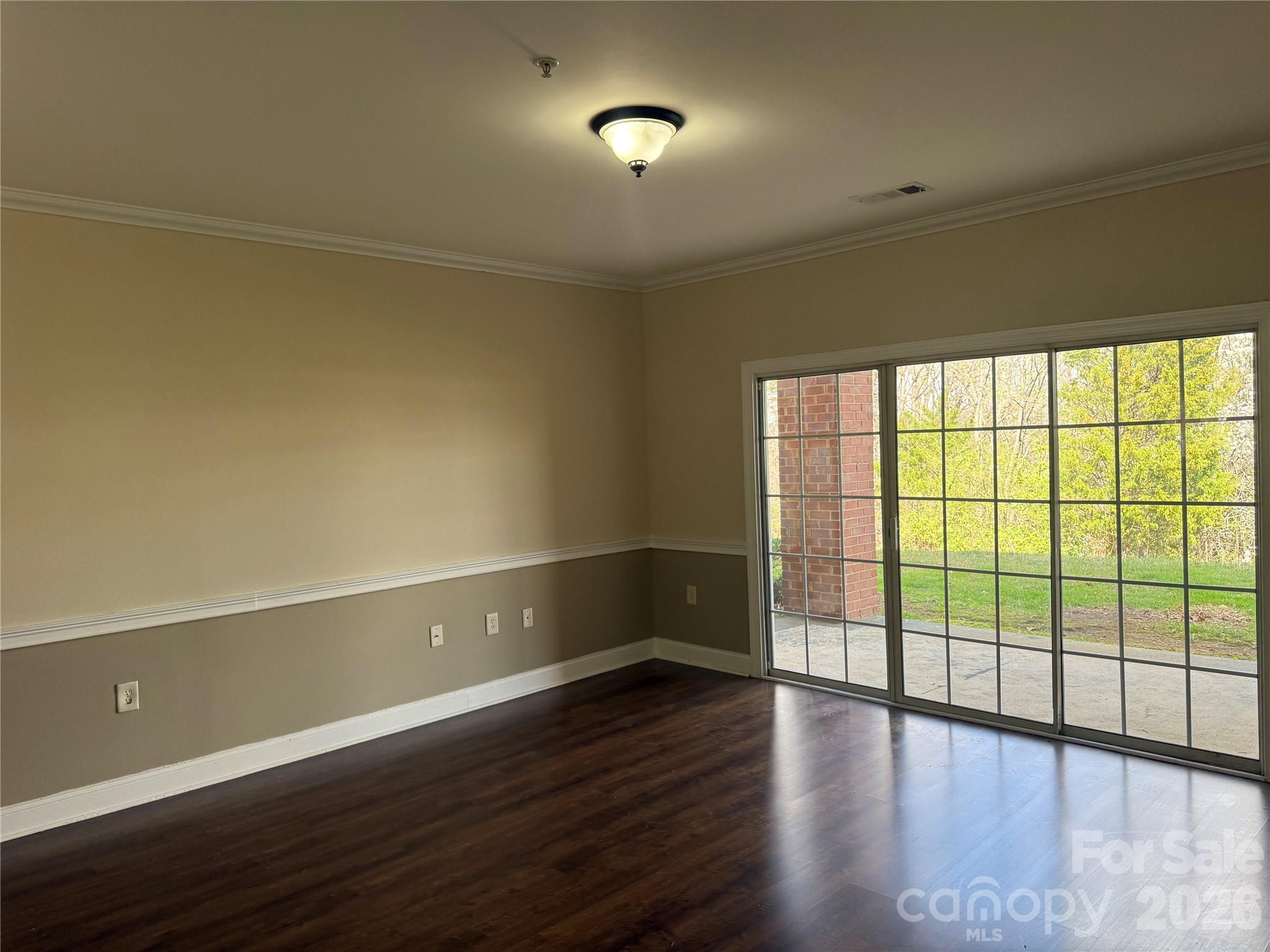 8913 Meadow Vista Road Charlotte, NC 28213 - Photo 25 of 30 a view of an empty room with wooden floor and a window