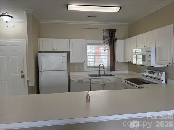 a kitchen with a refrigerator and a sink