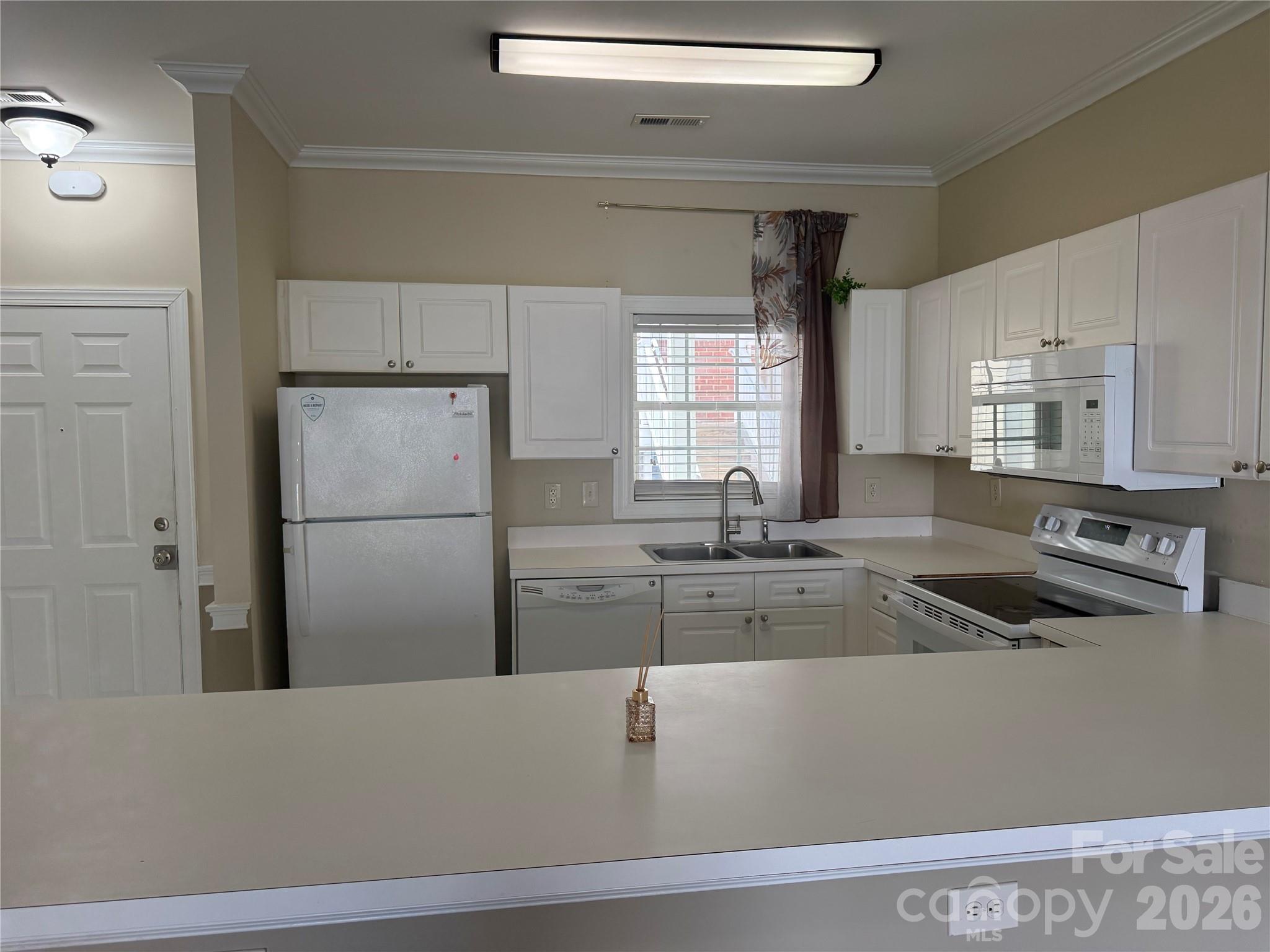 8913 Meadow Vista Road Charlotte, NC 28213 - Photo 6 of 30 a kitchen with a refrigerator and a sink