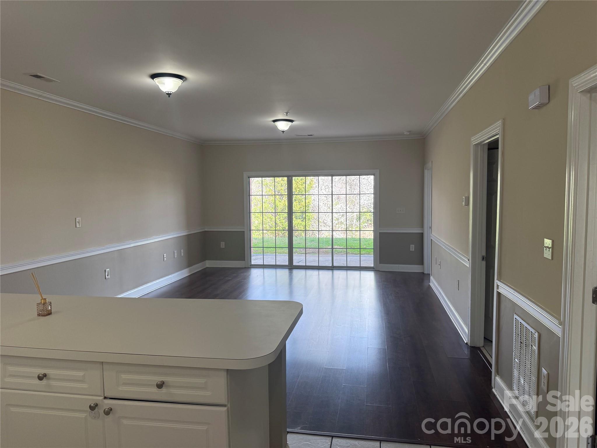 8913 Meadow Vista Road Charlotte, NC 28213 - Photo 7 of 30 a view of an empty room with wooden floor and a window
