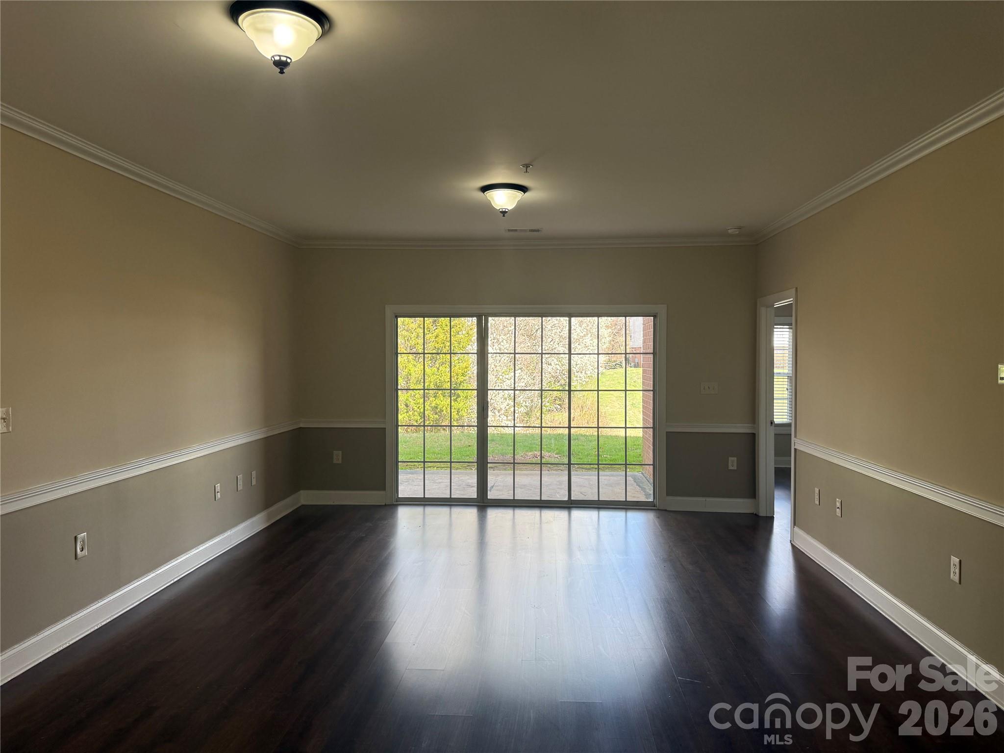 8913 Meadow Vista Road Charlotte, NC 28213 - Photo 10 of 30 a view of an empty room with wooden floor and a window