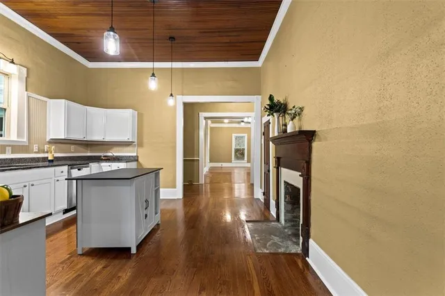 a kitchen with stainless steel appliances granite countertop a stove and wooden floor
